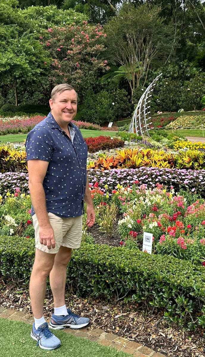 David Hunt in a garden with flowers